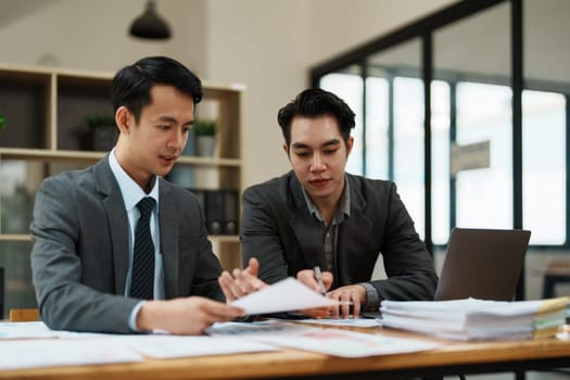 Asian business advisor meeting to analyze and discuss the situation on the financial report in the meeting room.Investment Consultant, Financial , teamwork ,brainstorming ,startup and accounting.