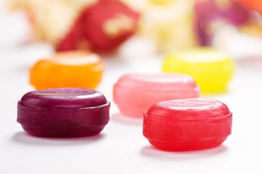 Several colorful lollipop candies closeup on white surface