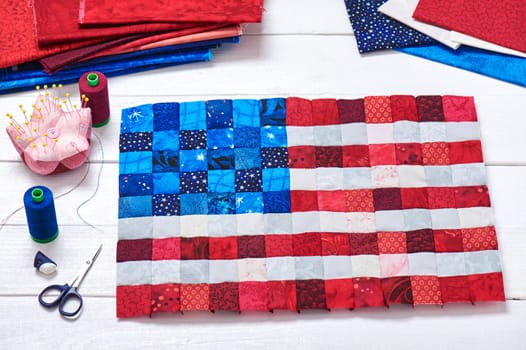 Square pieces of fabrics selected and stitched like a flag of USA