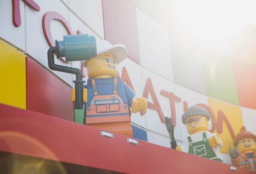 Billund, Denmark, July 2018: big plastic Lego mans on the roof of a gift shop in Legoland in Denmark