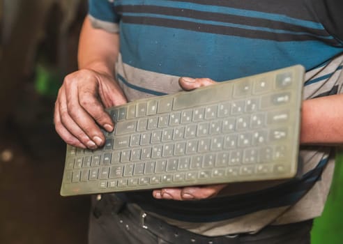 dirty hands of a worker who sets up a cnc machine.