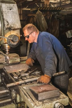 Bila Tserkva, Ukraine, September 2020: locksmith working on a drilling machine in a factory