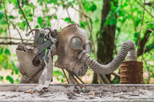 two old gas masks on a school windowsill in Pripyat.