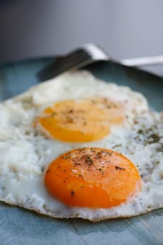 Fried eggs in the plate close up ,,