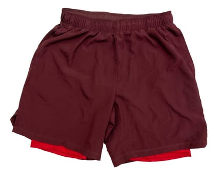 Red two-layer running shorts isolated on white background. Sports shorts with leggings sewn inside for running, fitness, yoga and other workouts. Front view.