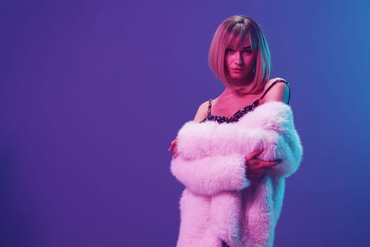 Sexy blonde woman in fluffy fur coat sparkly dress with open shoulders cross hands posing isolated in blue violet pink color light studio background. Neon party Fashion concept. Copy space Banner