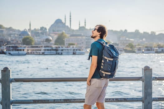 Young man traveler in pinc dress enjoying great view of the Bosphorus and lots of seagulls in Istanbul.