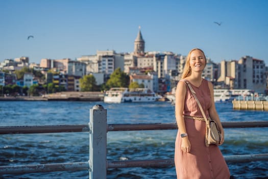 Portrait of beautiful woman tourist with view of Galata tower in Beyoglu, Istanbul, Turkey. Turkiye.