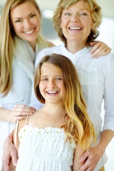 Wearing a lovely summer dress. A cute young girl in a summer dress enjoying quality time with her grandmother and mother