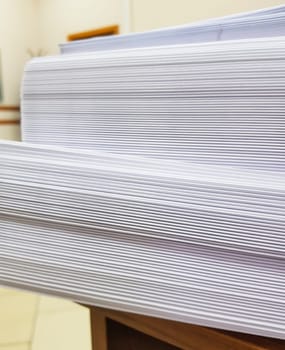 A stack of blank paper, book blocks prepared for binding in a printing house.