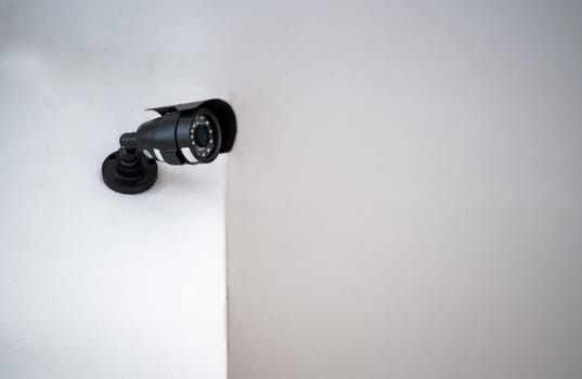 CCTV cameras installed on a white wall. Concept of surveillance and monitoring.