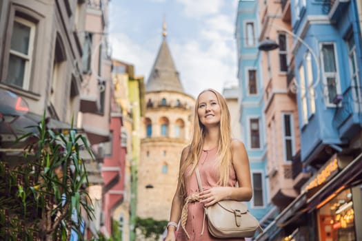 Portrait of beautiful woman tourist with view of Galata tower in Beyoglu, Istanbul, Turkey. Turkiye.