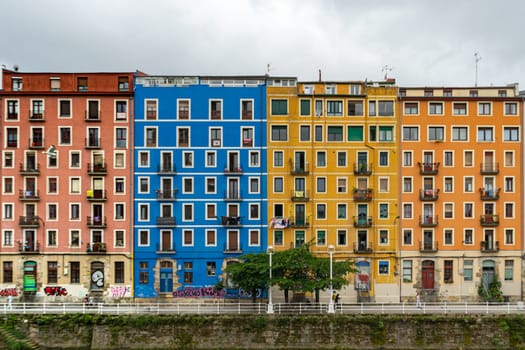 Bilbao, Spain - 08.06.2022: Bright multi colored houses of the Nervion River. Colorful architecture, Bilbao, Spain