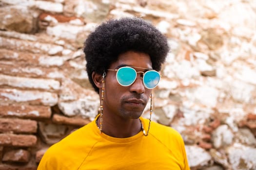 Portrait of cool and confident african american man wearing sunglasses outdoors. Lifestyle concept.