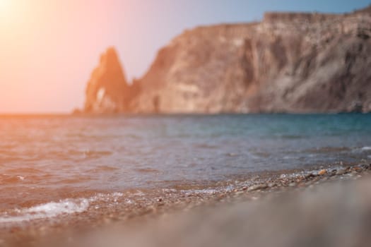 Abstract nature summer or spring ocean sea background. Small waves on water surface in motion blur with bokeh lights from sunrise.