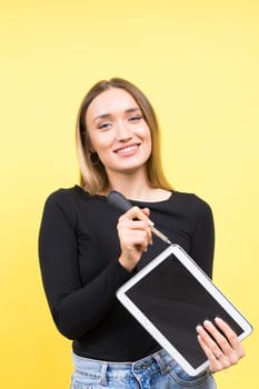 Service center. Laptop Repair. Female screwdriver unscrews laptop bolts on a yellow background