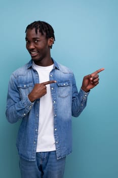 close-up portrait of a smart young stylish american guy with dreadlocks in a denim jacket with some kind of genius idea.