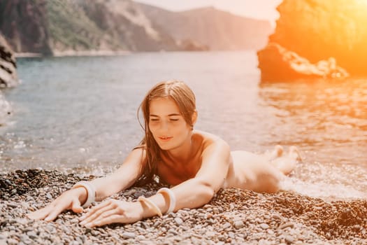 Woman travel sea. Happy tourist taking picture outdoors for memories. Woman traveler looks at the edge of the cliff on the sea bay of mountains, sharing travel adventure journey.