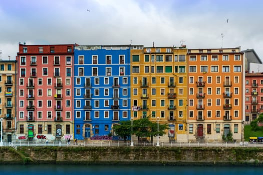 Bilbao, Spain - 08.06.2022: colorful architecture apartment buildings. Bright multi colored houses of the Nervion River Bilbao, Spain