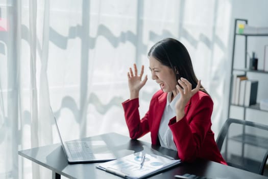 Portrait of business owner, woman using computer and financial statements Anxious expression on expanding the market to increase the ability to invest in business.