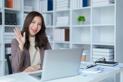 Beautiful young teen asian business woman meeting at on computer laptop with planning working on financial document, tax, exchange, accounting and Financial advisor.