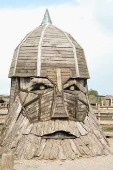 The big face of the wooden sculpture of the hero.