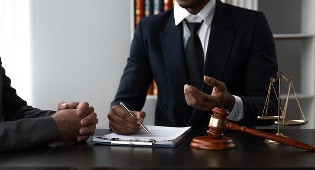Consultation and conference of Male lawyers and businesswoman working and discussion having at law firm.