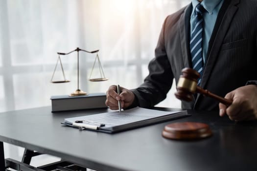 Male lawyer working at table in office.