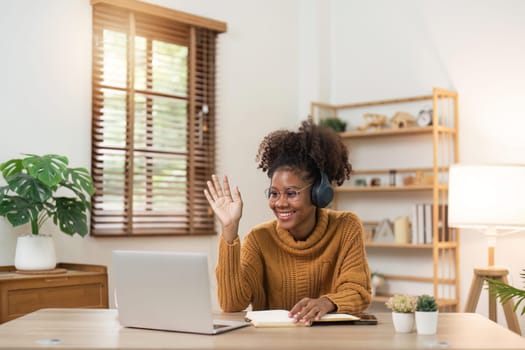 Holiday and leisure ideas of young African women who video accompany family or friends use laptop at cozy home.