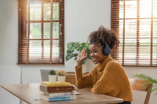 Holiday and leisure ideas of young African women who video accompany family or friends use laptop at cozy home.