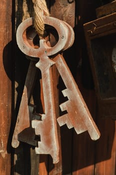 A bunch of old wooden keys hanging on a rope, close-up.