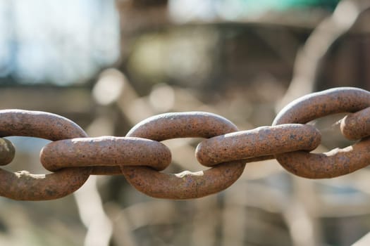 Old rusty metal chain outdoors. Large chain links.