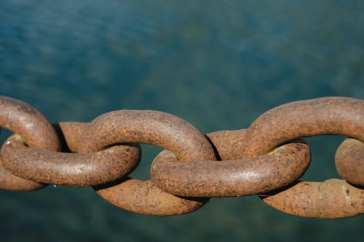 Old rusty metal chain outdoors. Large chain links.