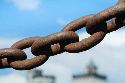 Old rusty metal chain outdoors. Large chain links.