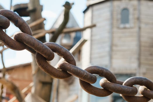 Old rusty metal chain outdoors. Large chain links.