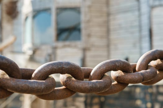 Old rusty metal chain outdoors. Large chain links.