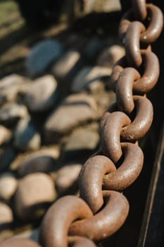 Old rusty metal chain outdoors. Large chain links.