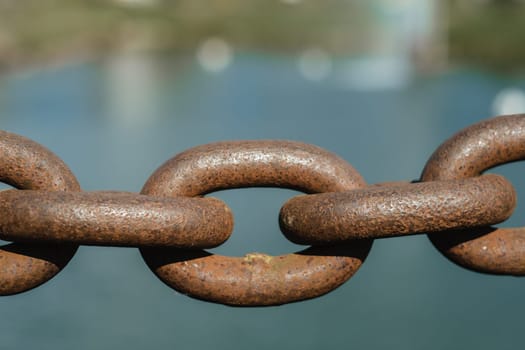 Old rusty metal chain outdoors. Large chain links.