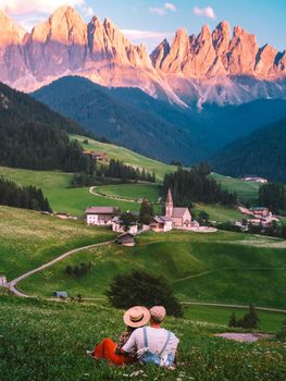 couple on vacation in the Italian Dolomites, Santa Maddalena Santa Magdalena village with magical Dolomites mountains in autumn, Val di Funes valley, Trentino Alto Adige region, South Tyrol, Italy, Europe. Santa Maddalena Village, Italy. 
