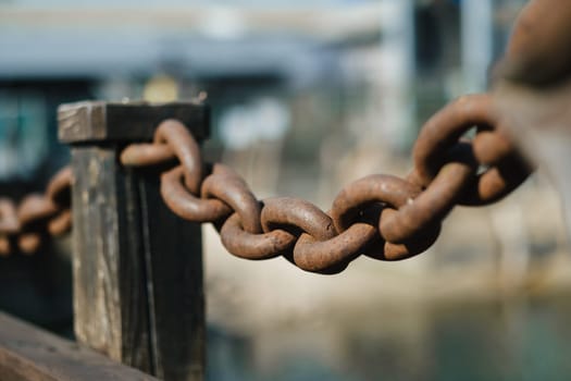 Old rusty metal chain outdoors. Large chain links.