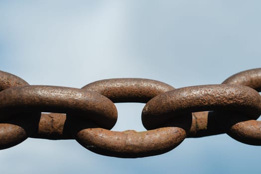 Old rusty metal chain outdoors. Large chain links.