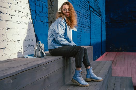 Portrait of a stylish woman in blue jacket. Spring outdoor portrait.