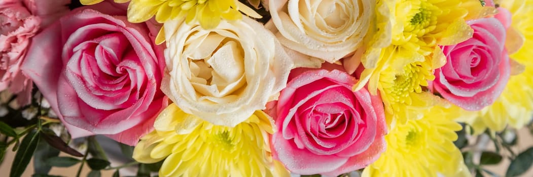 Beautiful summer banner for a website with a bouquet of bright flowers on a modern pink background.