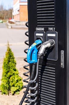 Electric vehicle Charging station. plug-in power cable. A power supply for charging an electric vehicle. Eco electric concept. Car charger. Alternative fuel. green energy technology