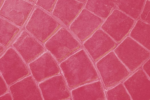 Background of ceramic tiles in new trendy color of 2023 Viva Magenta. Monochrome. Abstract.