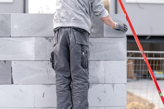 craftsman builds a house from concrete bricks. High quality photo