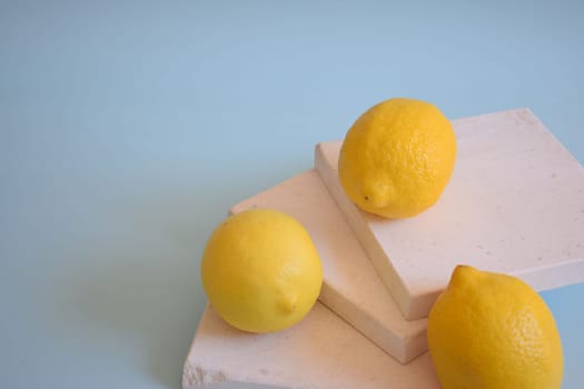 Fresh lemons on a blue background.