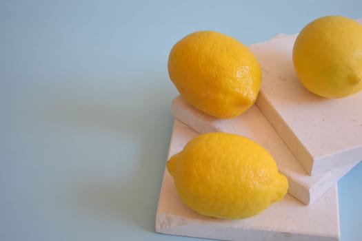 Fresh lemons on a blue background.