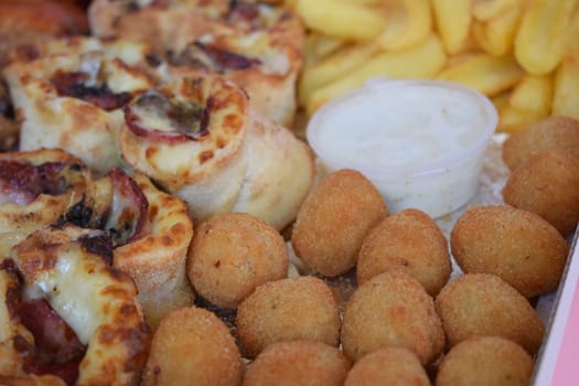 Fast food mix, pizza rolls, cheese meatballs, fries, chicken wings.