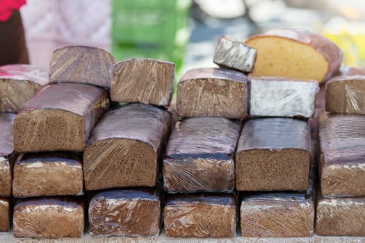 Buy bread at the store. Black and white bread on the bakery counter. Buying fresh bread, seeded black rye and hemp seeds